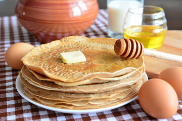pancakes with honey butter eggs and glass of milk
