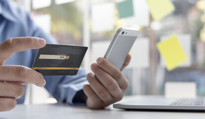 Businessman use mobile phones to register for security Online with a credit card to buy products online through application, Online shopping or Internet technology concept.