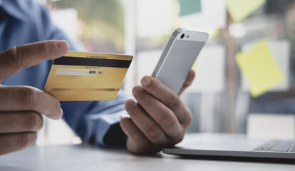 Businessman use mobile phones to register for security Online with a credit card to buy products online through application, Online shopping or Internet technology concept.