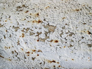 Flaky white paint with falling layers. The effect of decay into details. Stock photo for retro texture overlay.