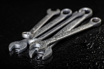 Water drops on workshop wrenches. Wet tools used in a machine shop.