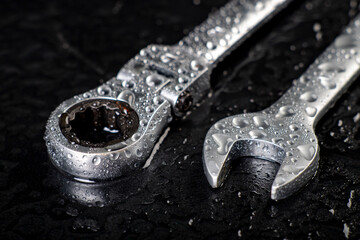 Water drops on workshop wrenches. Wet tools used in a machine shop.