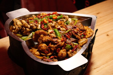 close up Chinese spicy dry braised frog in pot on table.  Chinese dry pot frog