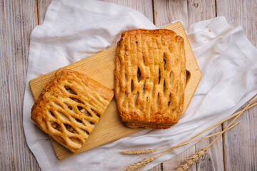 Top view on fresh baked apple and nuts pie on the wooden cutting board