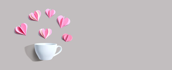 Coffee cup with paper craft hearts - flat lay
