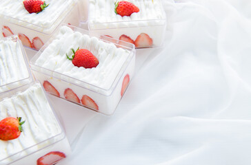 strawberry shortcake in plastic box on with cloth background and copy space, Minimal cake