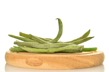 Frozen green beans on a wooden tray, close-up, isolated on white.