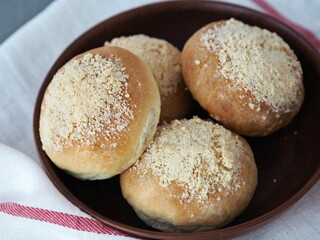 Round burgers in a natural earthenware plate. Ready to eat. Home cooking concept.Bread and rolls.