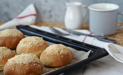 Butter burgers on a black baking sheet from the oven with a glass of tea or coffee.Ready to eat. Home cooking concept. Bread and rolls.