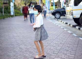 A girl wearing a massager to protect Covid-19.