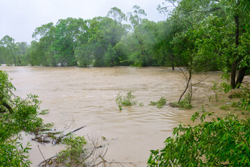 The river overflowed its banks after prolonged heavy rains, an environmental problem, a natural phenomenon.