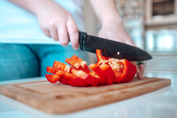 Pepper is cut with a knife