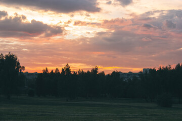Beautiful orange sunset over dark cityscape