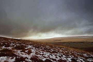 heavy clouds over bleak moorland