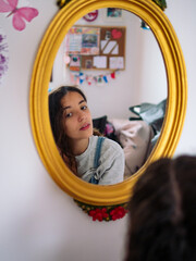 Obraz na płótnie Canvas image of a teenage girl reflected on a mirror