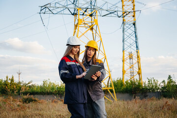 Women's collective of energy workers conducts an inspection of equipment and power lines. Energy