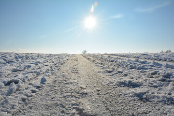 Snow-covered road in the country, a lot of snow in the fields