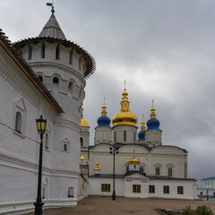 Assumption-Sophia Cathedral on the territory of the Tobolsk Kremlin (Siberia, Russia) in autumn. the gold and blue domes of the cathedral look beautiful against the textured gray sky