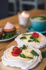 Meringue and whipped cream dessert layered with seasonal strawberry.