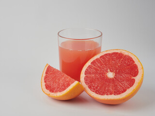 Glass of grapefruit juice isolated on white