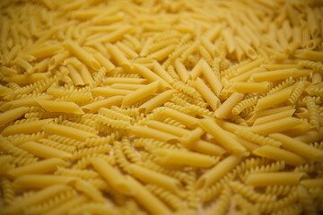 The texture of the pasta. Pasta across the frame. Background. Solid fill. Shooting at an angle. Selective focus. Blurring