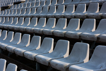 Empty grey  seats on a seating tribune.