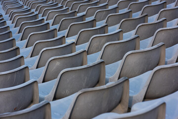 Empty grey  seats on a seating tribune.