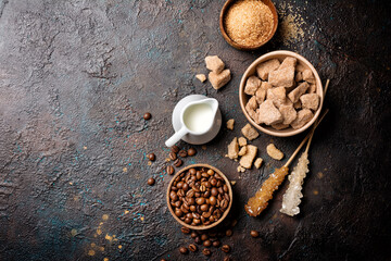 Ingredients for coffee drinks. Bowls of brown cane lump and granulated sugar, crystal sugar sticks,...