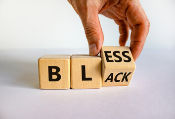 Bless black symbol. Hand flips a cube and changes the word 'black' to 'bless'. Beautiful white background. Bless black concept. Copy space.