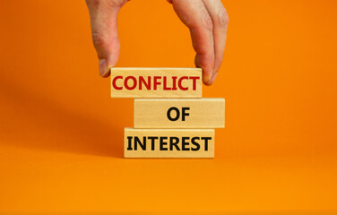Conflict of interest symbol. Businessman hand. Wooden blocks with words 'conflict of interest'....