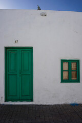 Fototapeta premium Closeup of a green door and window.