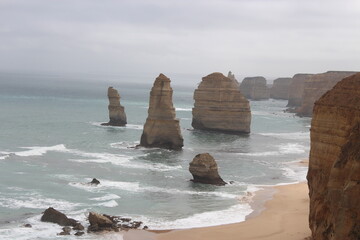 Limestone rocks appearing in water on a beach, Twelve Apostles