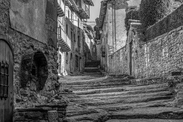 Amazing view of old natural stone street with a fountain in ancient medieval village of Rupit, Barcelona , Spain.Black and white photo style , vintage retro background.