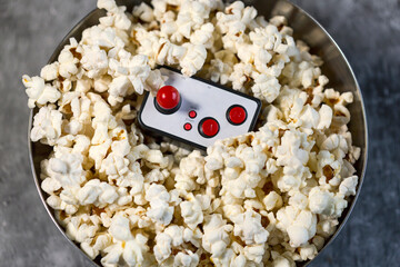 Obraz premium Video game controller inside a bowl of popcorn.