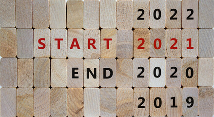 Symbol of start 2021 new year. Wooden blocks with the words 'end 2020, start 2021'. 2019, 2022...