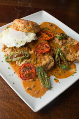 Chicken fried steak. Flank steak battered & deep fried in cast iron skillet. Classic American southern, low country cuisine. Made from scratch chicken fried steak served with gravy and side dishes.