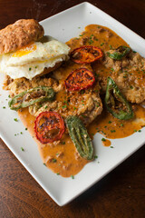 Chicken fried steak. Flank steak battered & deep fried in cast iron skillet. Classic American southern, low country cuisine. Made from scratch chicken fried steak served with gravy and side dishes.