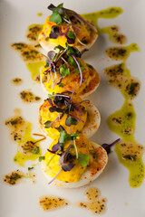 Devil eggs. Hard boiled eggs, cut in half and white pipped with yolk mixture. Garnished with...
