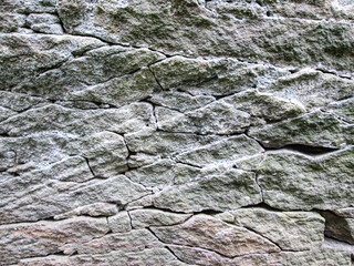 Cracks in a large old stone. Decaying rocky surface.