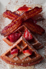 French toast. Classic American restaurant breakfast or brunch favorite. Brioche toast fried in butter and served with strawberries, blackberries, whipped cream powdered sugar and maple syrup.