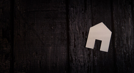 home on dark wooden background, home loan concept.