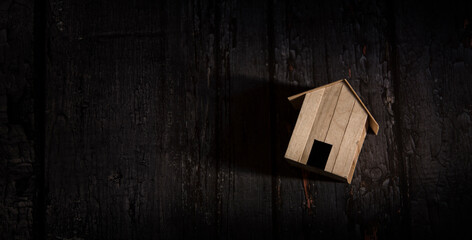 wooden home on dark wooden background, home loan concept.