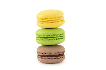 three multi-colored cookies stand on top of each other on a white background. Macaron. Yellow, green, brown. Close-up, horizontal photo.