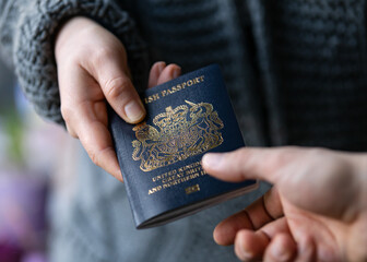 man handing new post Brexit blue British passport Devon, United Kingdom, January, 2021