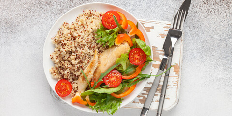 Diet lunch - chicken breast with quinoa and salad of fresh vegetables and leaves. Top view