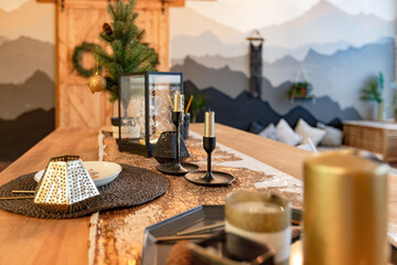 On the eve of the holiday, the interior of the country house is decorated with a New Year tree. large spacious light room decorated with wood with simple wood furniture