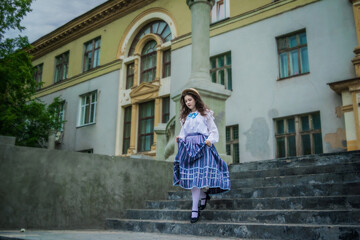 Cheerful girl runs down the steps