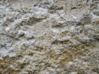 Grainy texture of sandy stone. Rough surface with golden dots.