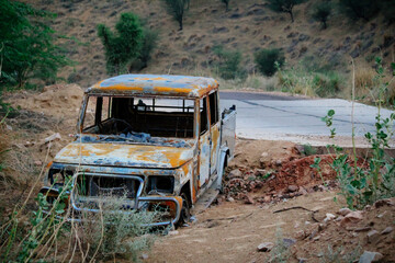 Abandoned and burnt-out car. A burnt-out car left abandoned at the road side of a quiet rural...