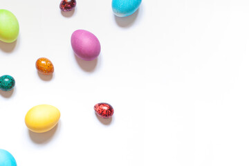 Colorful painted Easter eggs on the white background. Top view	,
